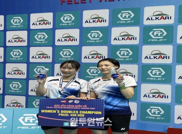 구로구청 배드민턴팀 김하나·전주이 선수가 시상식 후 트로피와 함께 기념 촬영을 하고 있다.